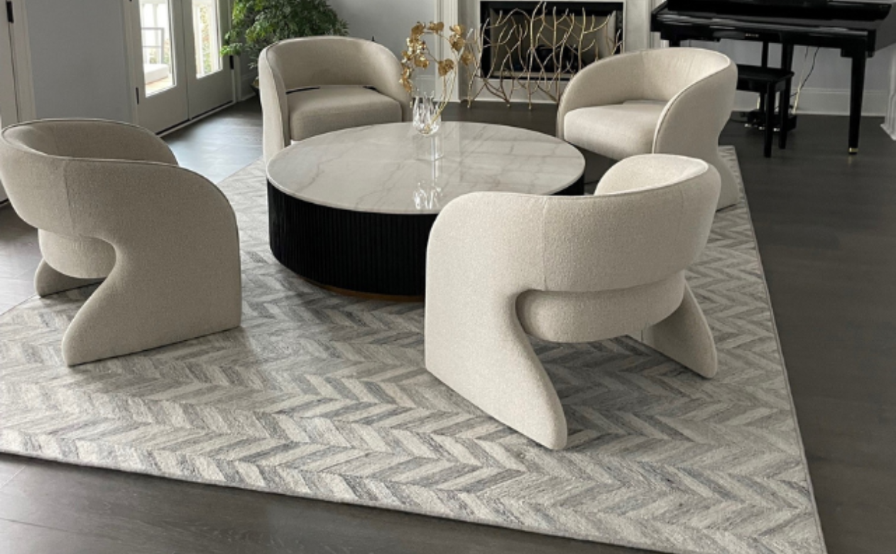 Living room with soft grey and cream furniture and carpet.